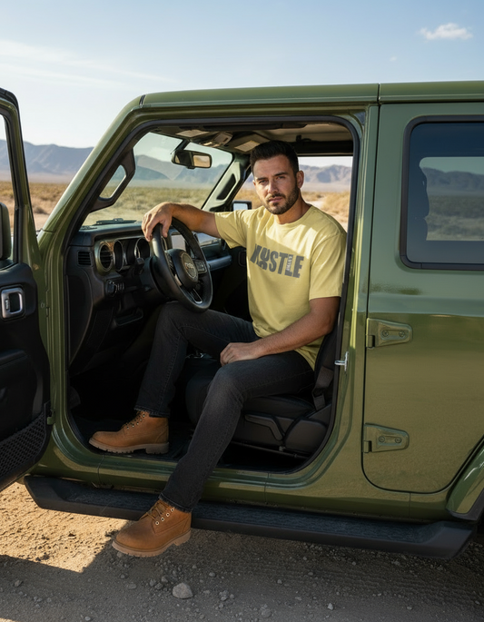 Man sitting inside a green vehicle in a desert landscape